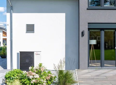 Wärmepumpe SolvisMia vor großen Einfamilienhaus.